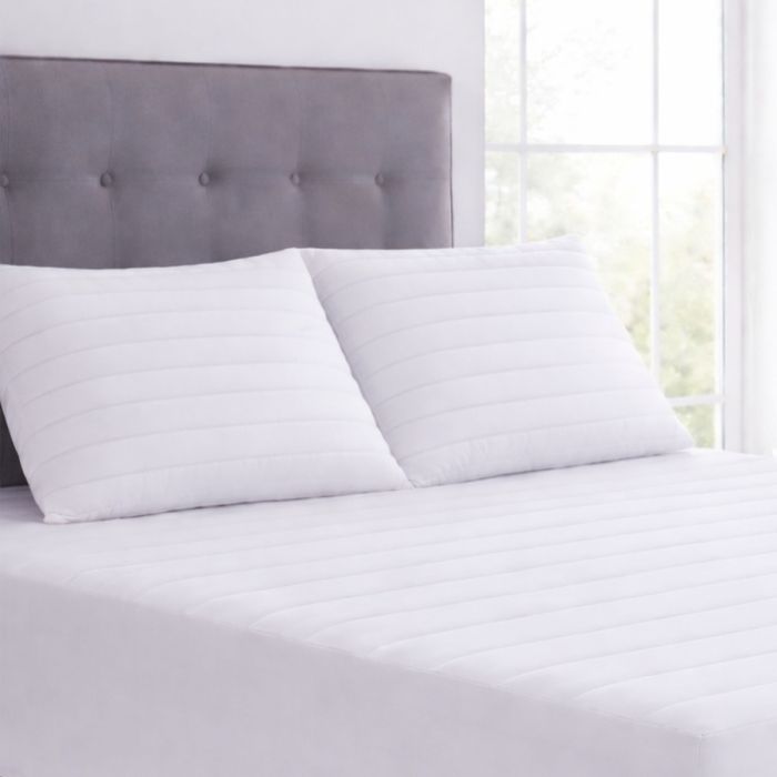 Two Silentnight Anti-Allergy Pillow Protectors on a grey bed 