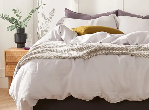 Premier Inn bed with bedding in a sunny warm room