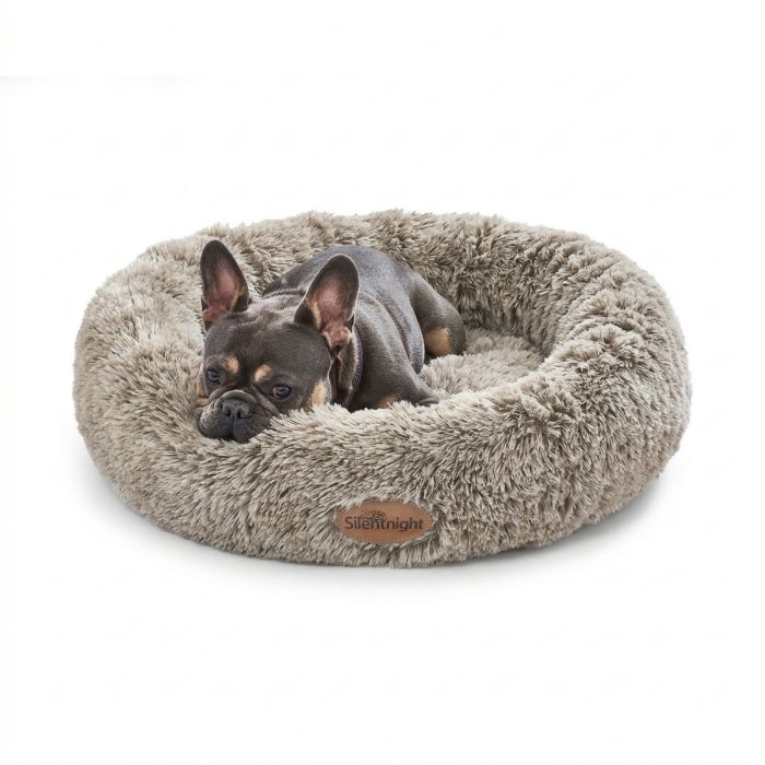 A dog lay on a Natural Silentnight Calming Donut Pet Bed