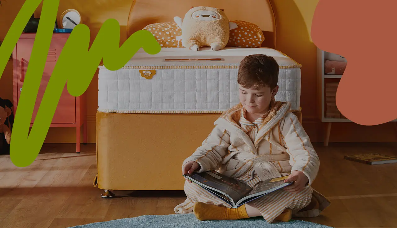 Child reading a book in the bedroom