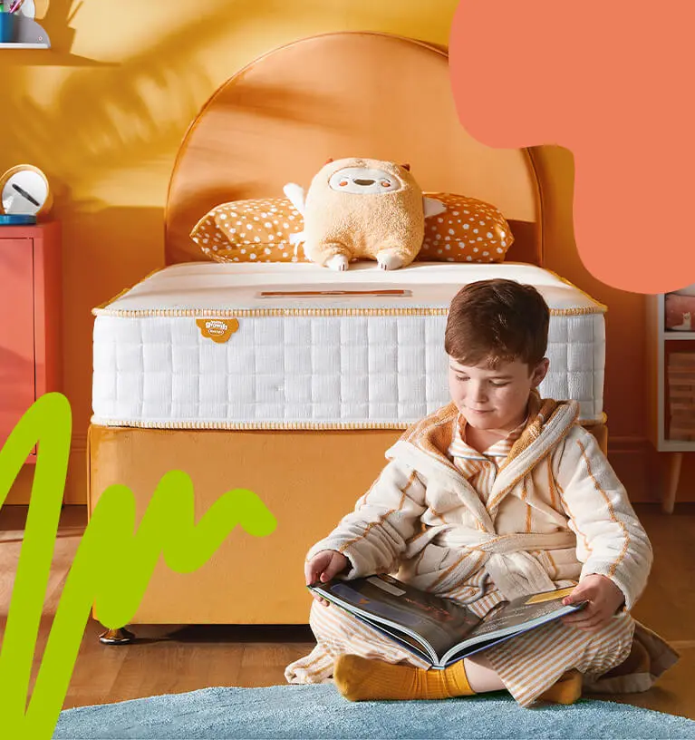boy sat on the floor reading book