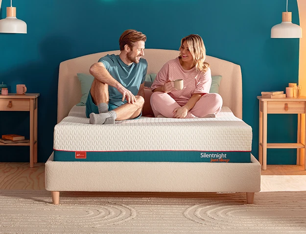 Two people with a sitting on a just serene mattress