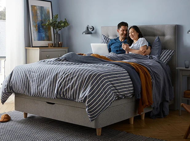 couple in bed working on computer