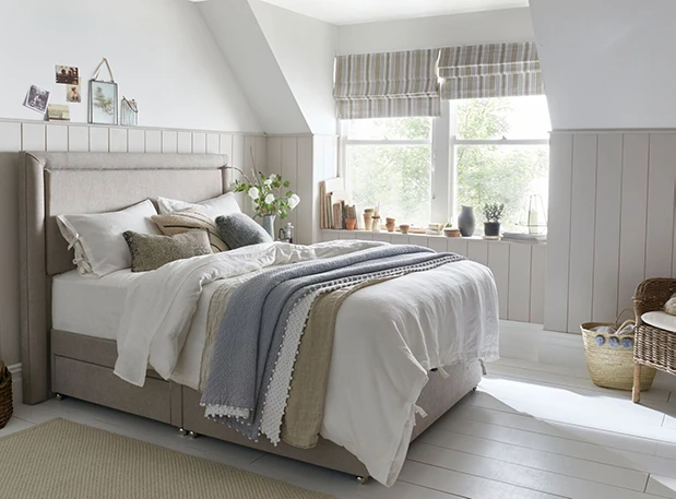 dressed divan bed in airy bedroom