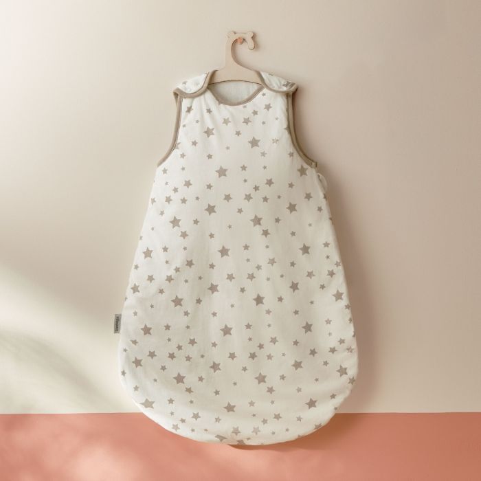 Silentnight Safe Nights Stars Baby Sleep Bag with grey stars hung on a white wall
