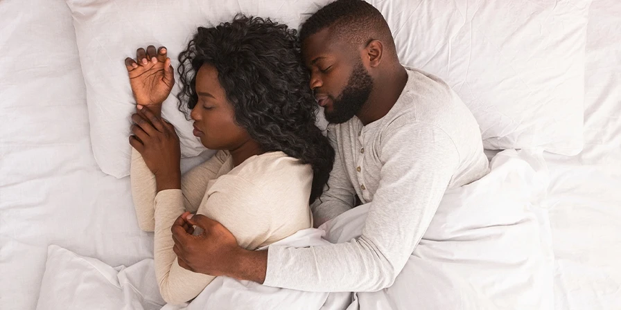 Couple sleeping cosily together