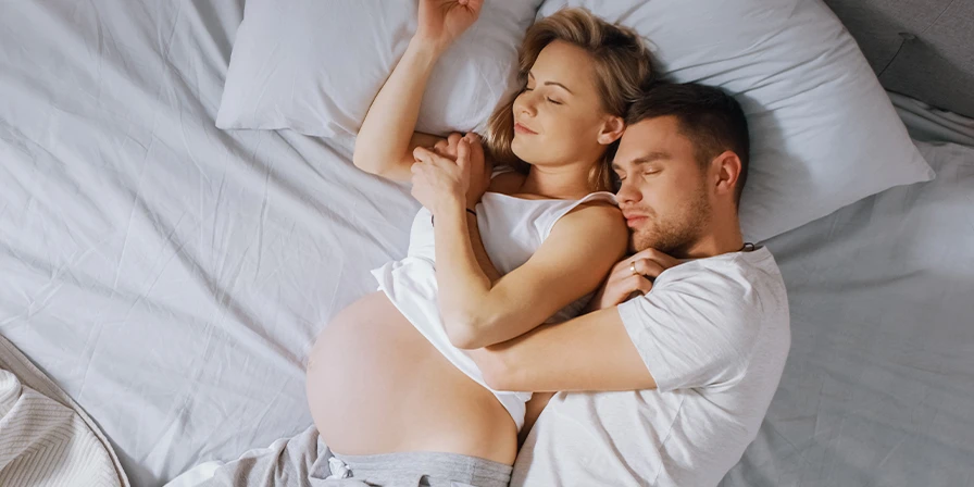Sleeping pregnant woman and partner