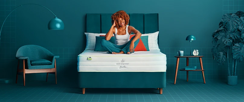 woman sat on mattress with crossed legs