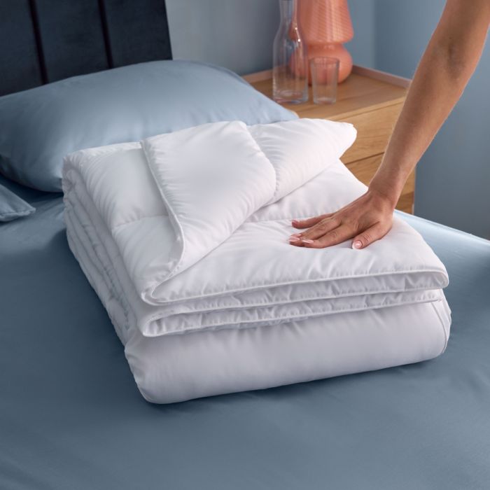 Silentnight Summer breeze duvet folded in a blue room.