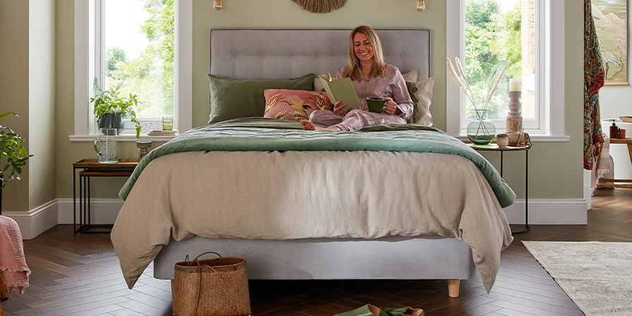 woman sat reading in bed