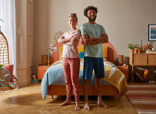 Couple standing in front of a memory mattress