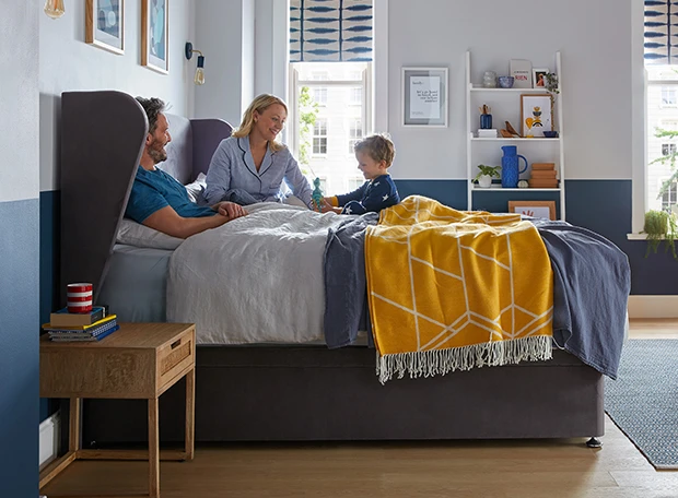 Family laughing on the bed