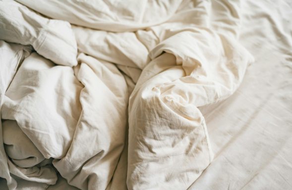A white duvet and bed linen