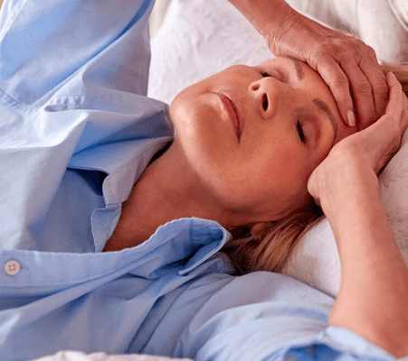 woman experiencing symptoms of menopause while sleeping