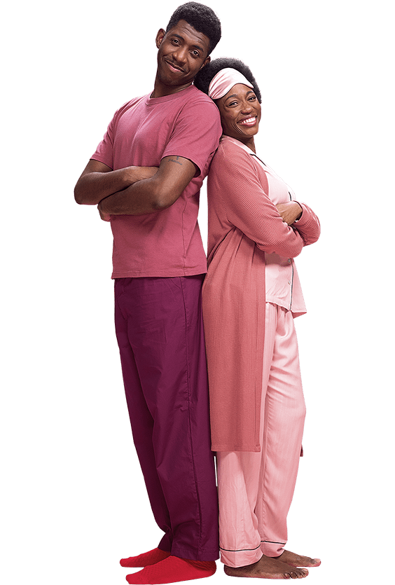 A couple standing back to back in pink Pyjamas